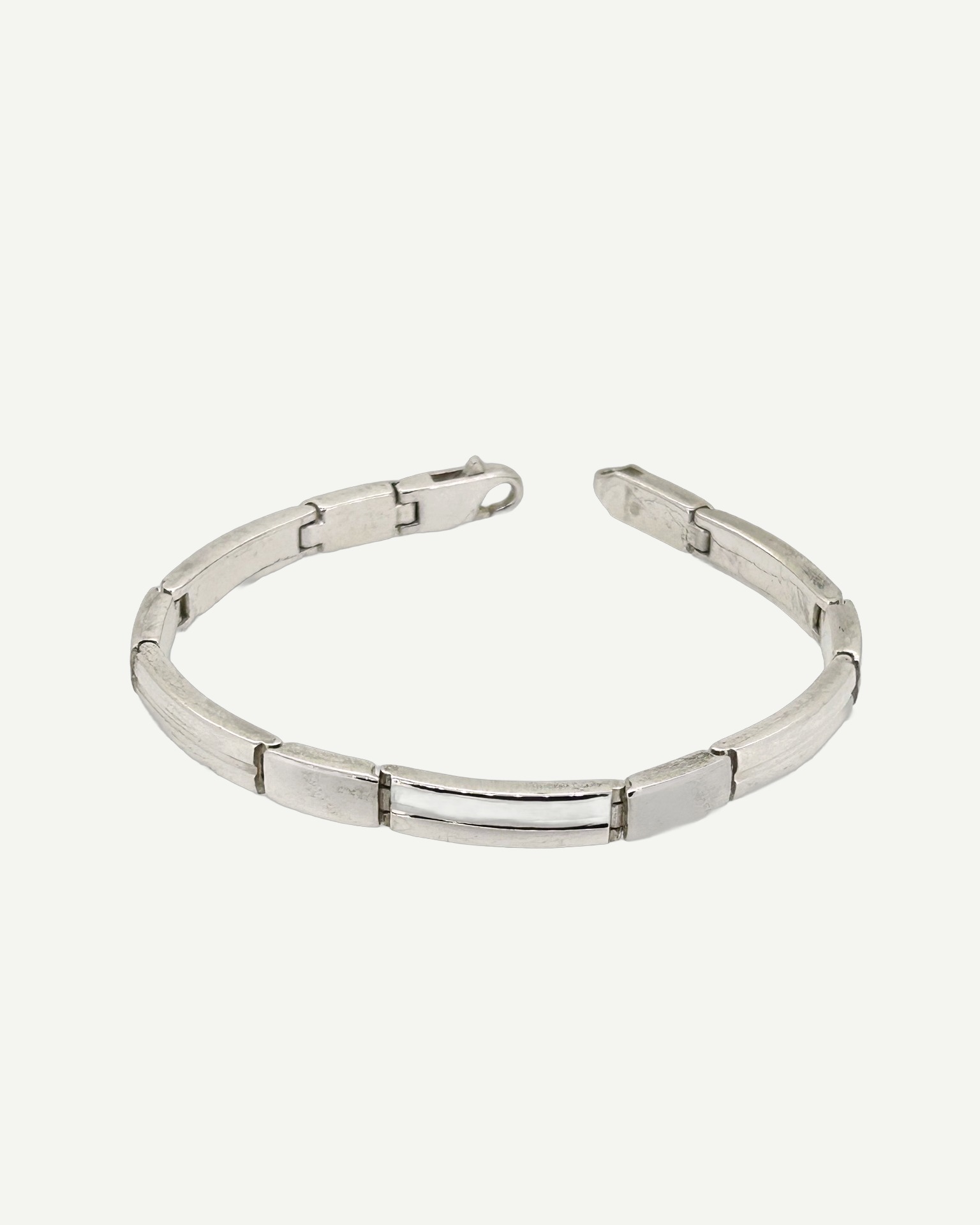 Silver hinged bracelet, A silver hinged bracelet with a panel-link design.