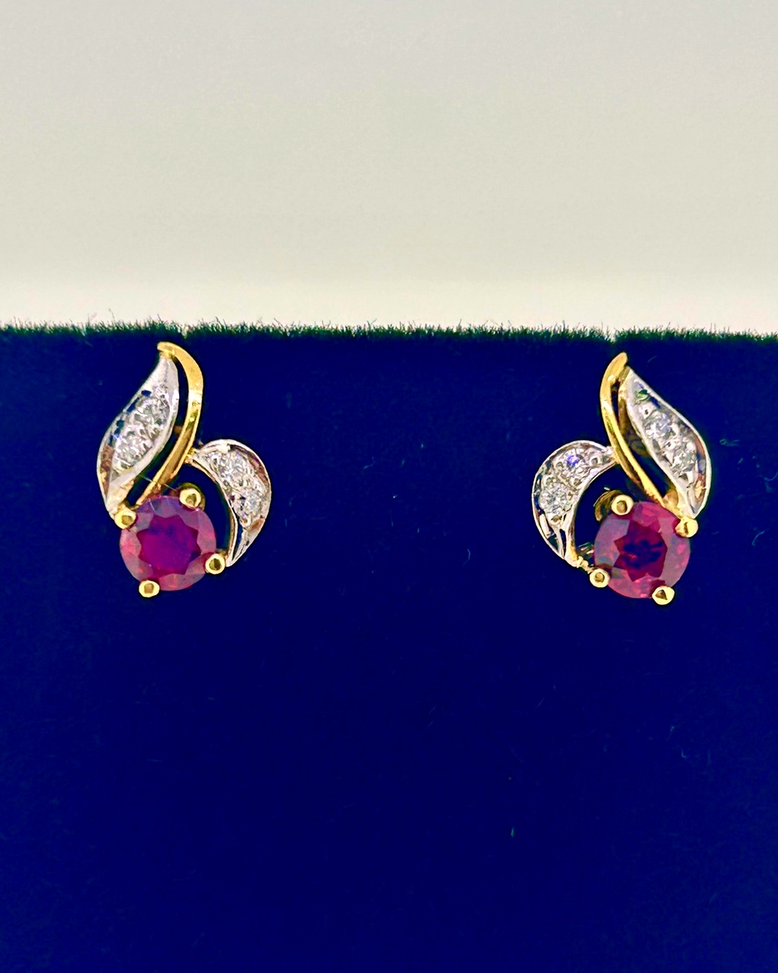 18-carat Yellow Gold Ruby and Diamond Stud Earrings, Ruby and diamond stud earrings in a floral leaf design.