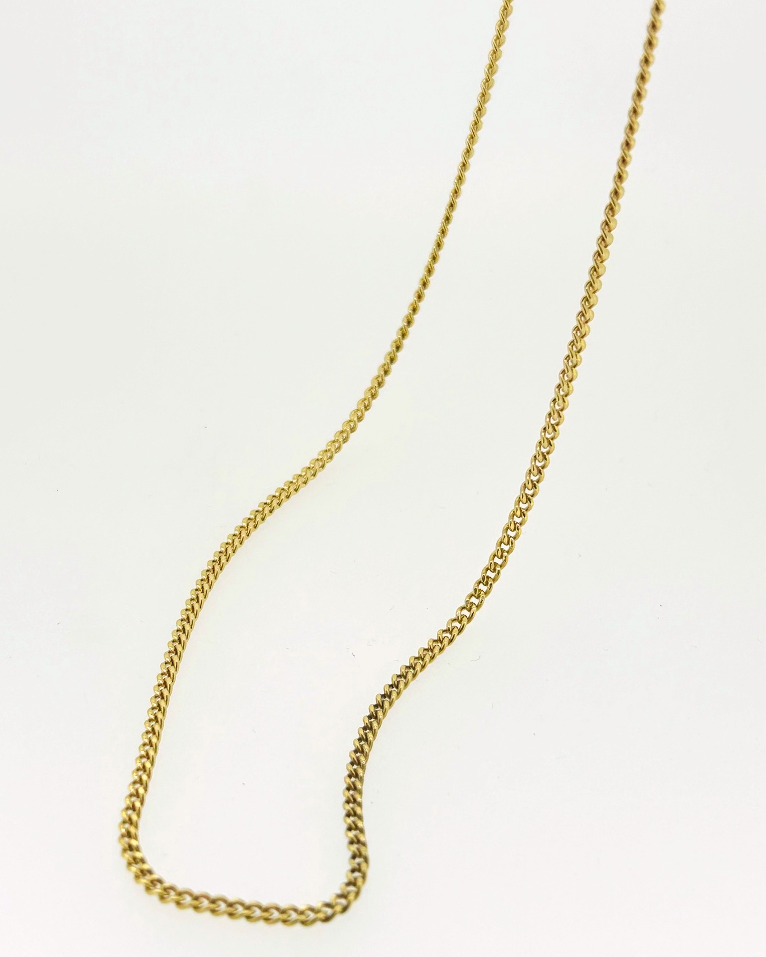 18-carat Yellow Gold Curb Chain 60 cm, A yellow gold curb chain. Weight: 10 g.
