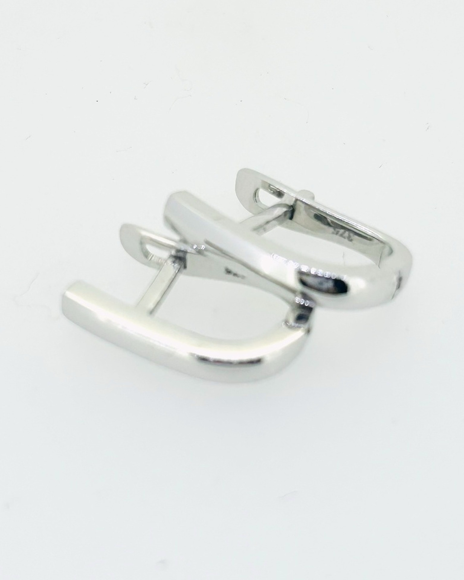 9-carat White Gold Oval Square Tube Huggie Earrings, Oval square tube huggie earrings in white gold. Weight: 2.3 g.