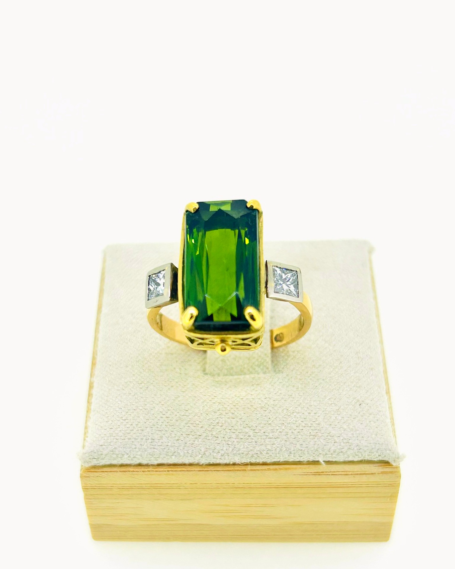 18-carat Yellow Gold Green Tourmaline Diamond Ring, A bold ring with a green tourmaline and diamond shoulders.