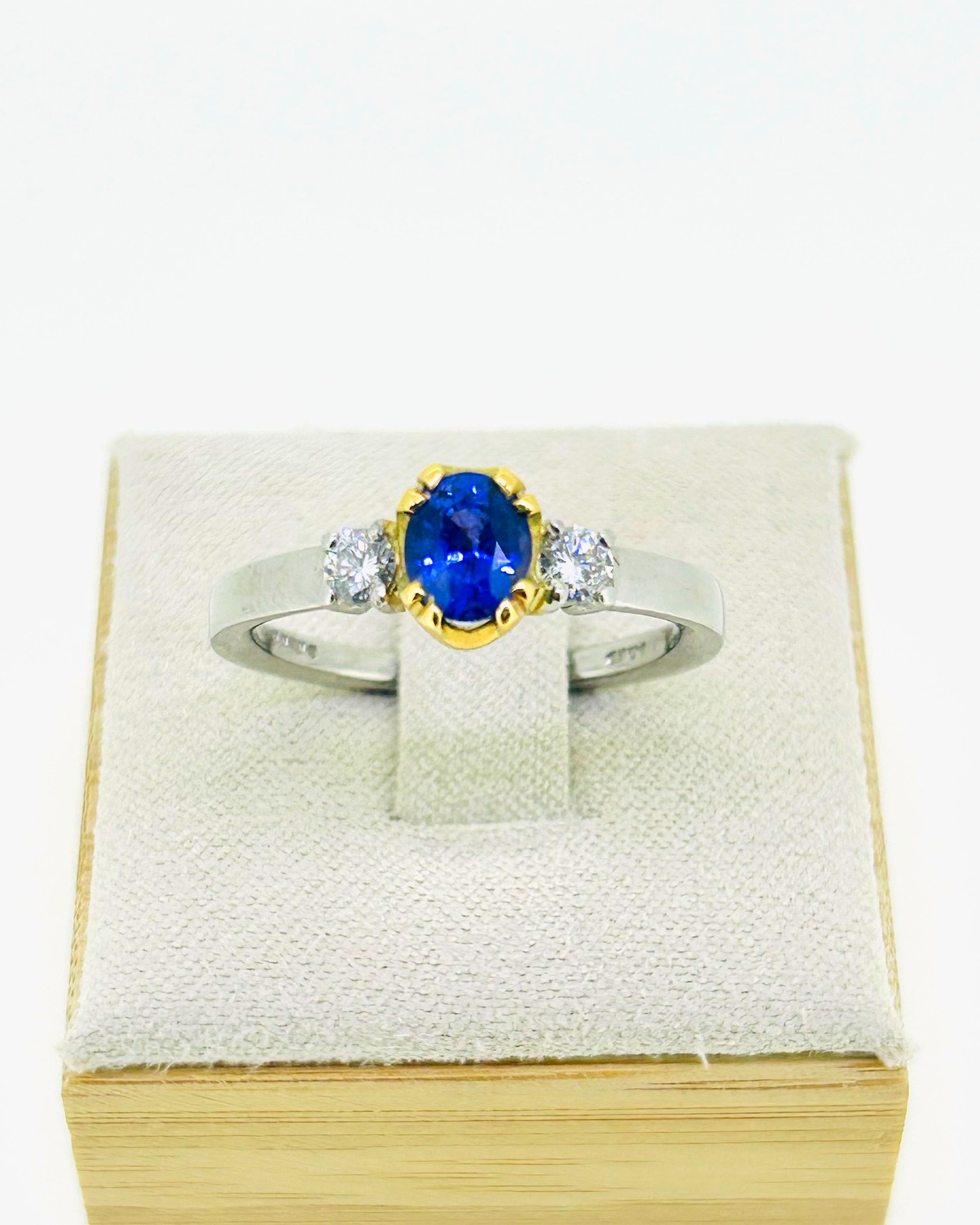 18-carat Yellow Gold Platinum Sapphire and Diamond Ring, A sapphire ring with diamond accents in yellow gold and platinum.