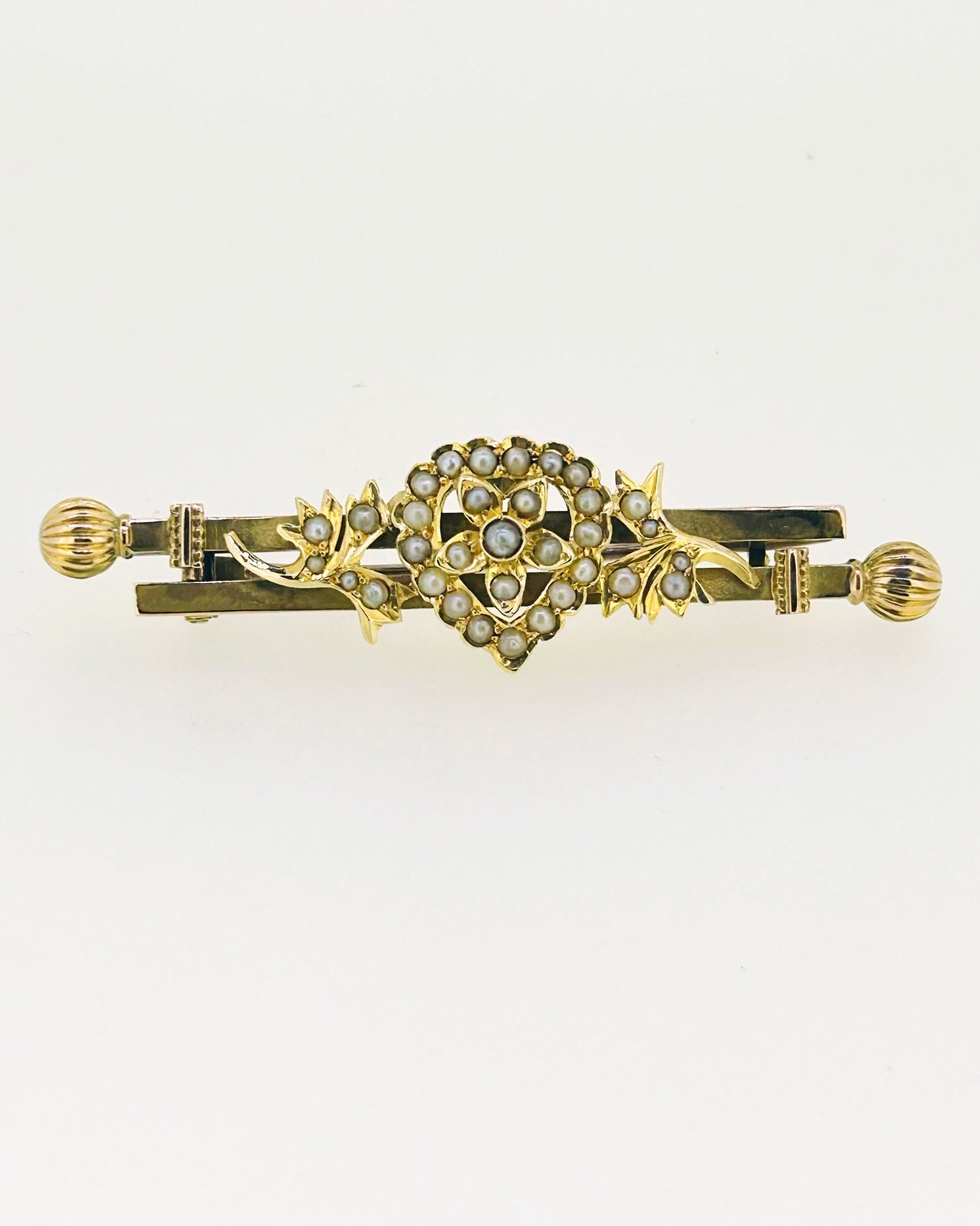 Antique 15-carat Yellow Gold Seed Pearl Bar Brooch, An antique bar brooch with seed pearl floral detail. Weight: 6 g.