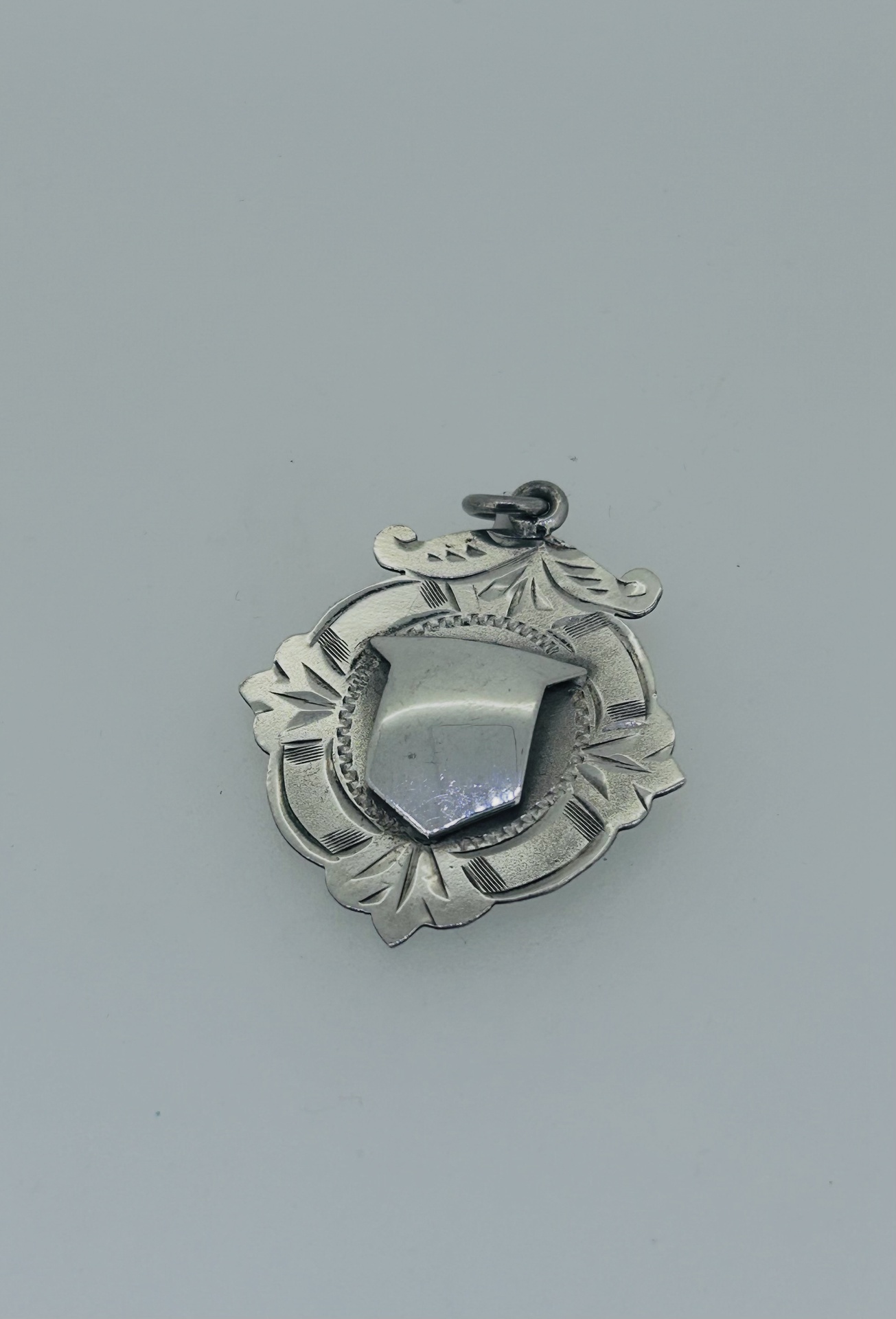 Silver vintage medal pendant, A decorative vintage-style silver medal pendant.