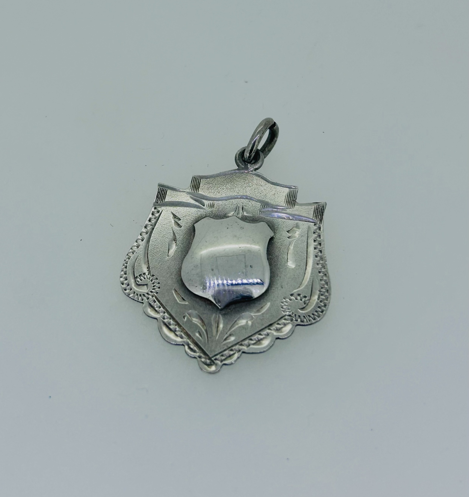 Silver vintage shield-style medal pendant, Decorative shield-style silver vintage medal pendant.