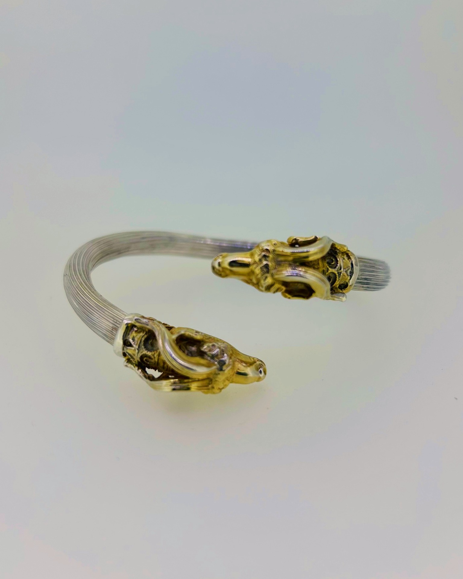 Silver bracelet with silver gilt goat heads, Bracelet with silver gilt goat-head terminals.