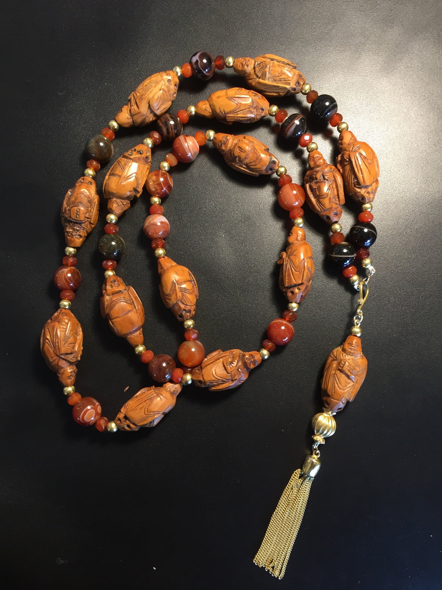 Buddha and agate beaded tassel necklace, Beaded necklace with carved Buddha-style elements. No weight stated.