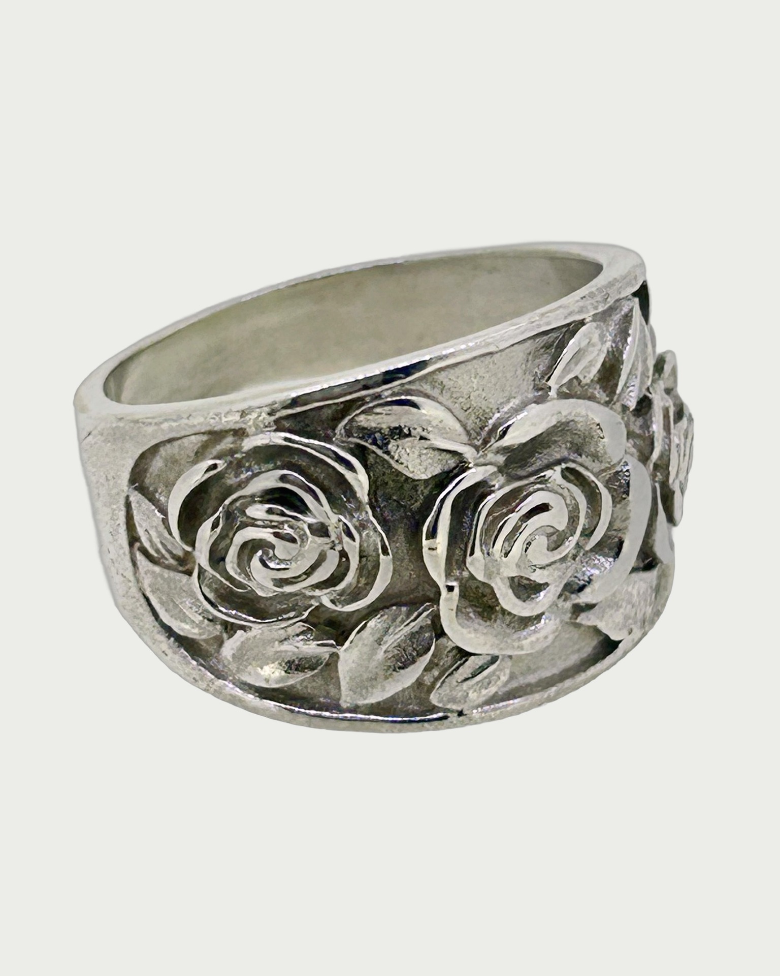 Silver Rose Embossed Ring, A wide silver ring with embossed rose motifs.