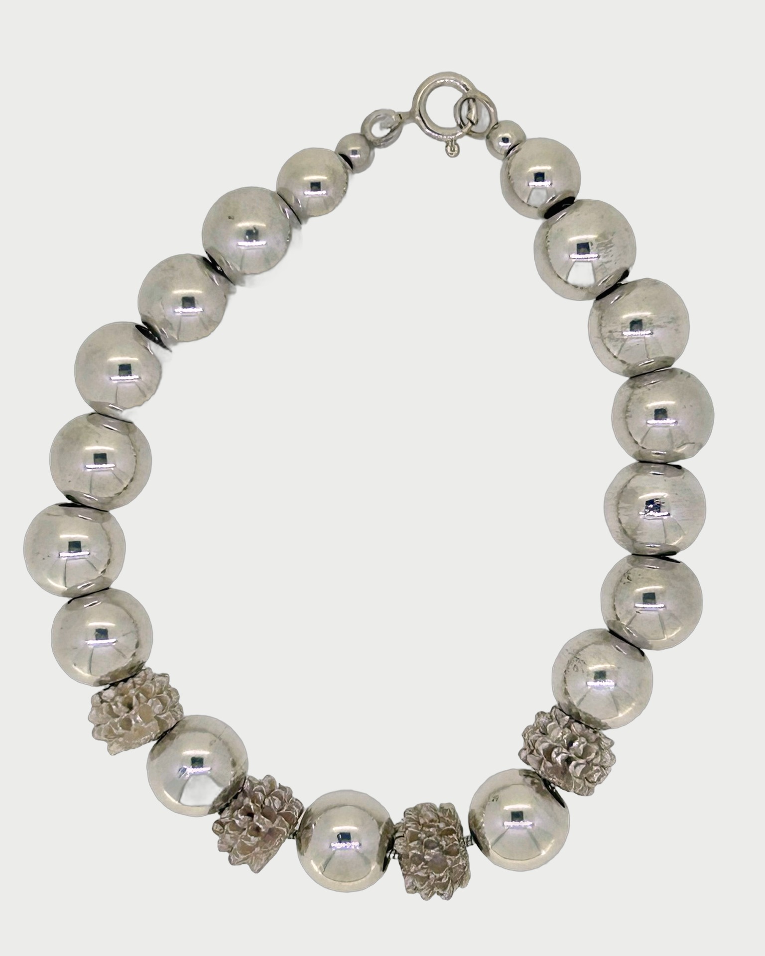 Silver Ball Bracelet, A polished silver ball bracelet with textured accent beads. Weight: 31.5 g.