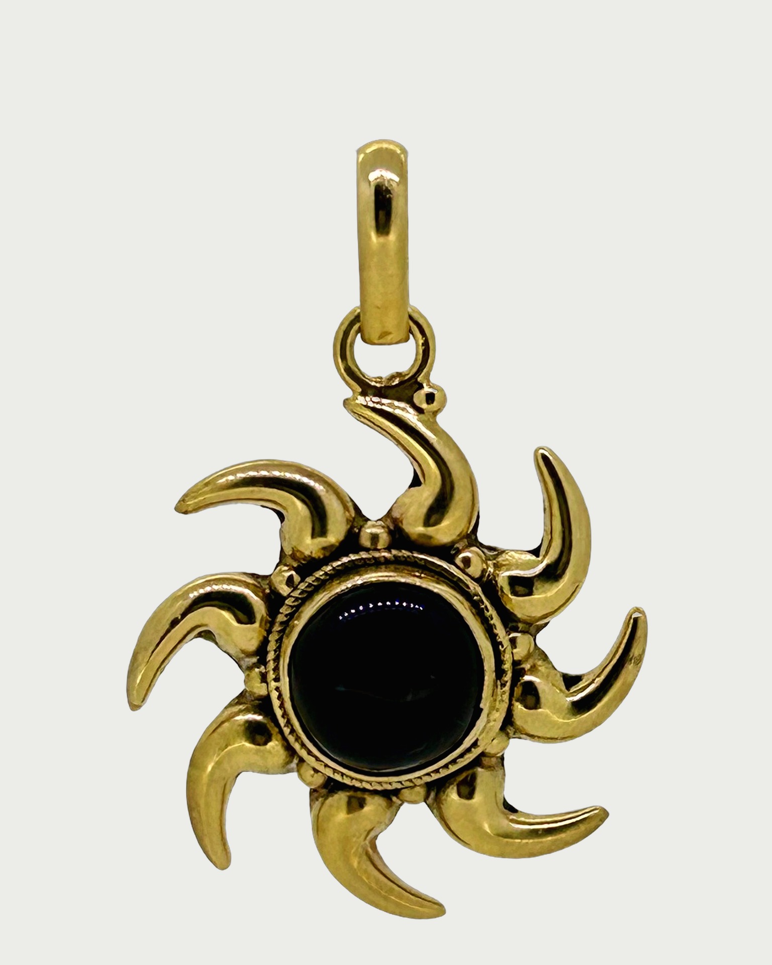 Silver Gilt Sun Pendant with Onyx, A sunburst pendant with a black onyx centre.