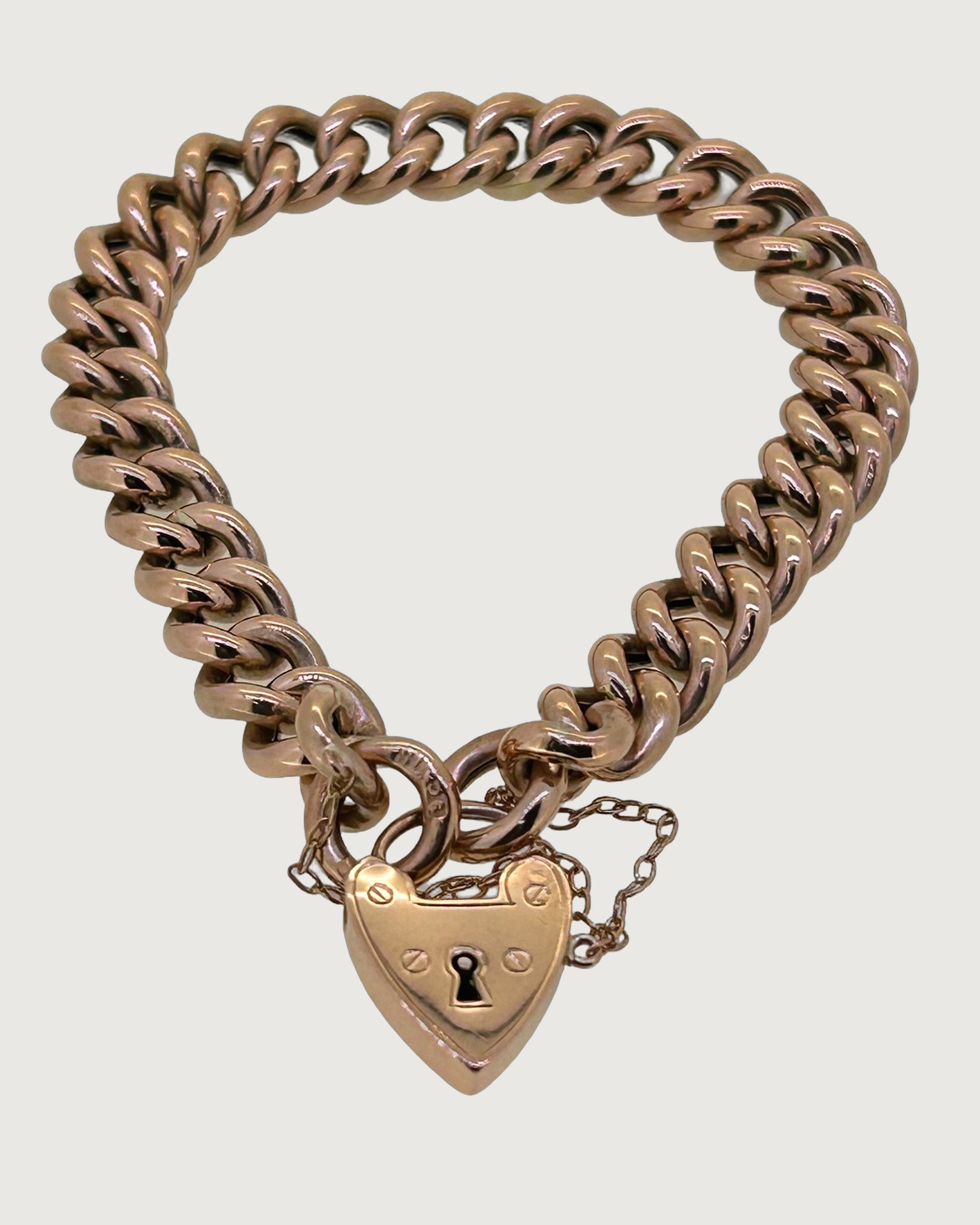 9-carat Rose Gold Curb Link Padlock Bracelet, A chunky curb link bracelet with a padlock clasp. Weight: 23.2 g.