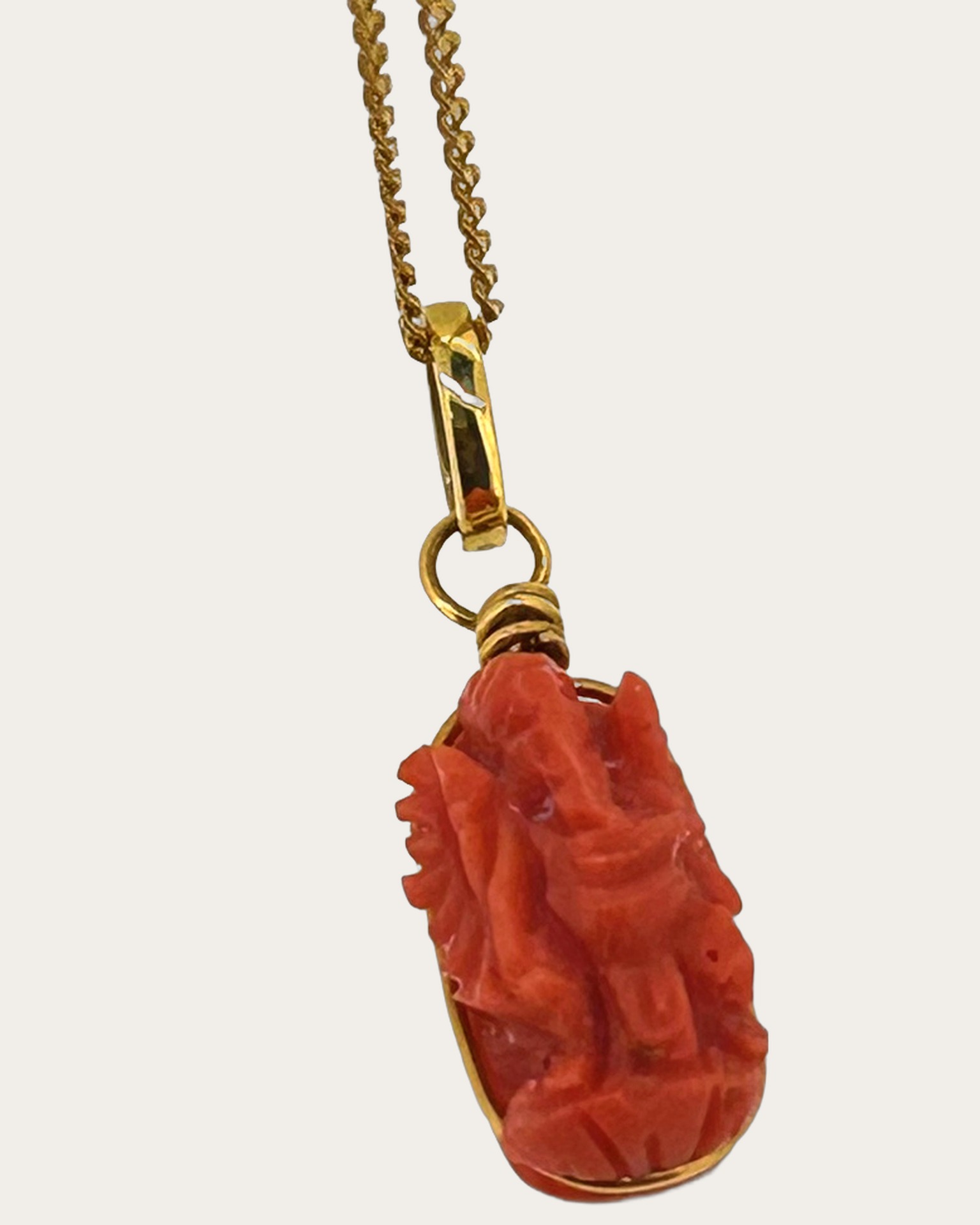 22-carat & 18-carat Yellow Gold Carved Coral Ganesh Pendant, Carved coral Ganesh pendant in Yellow Gold.